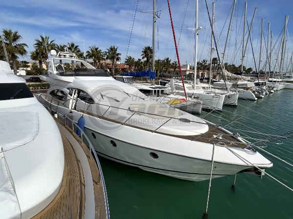 Azimut 68 Plus Luxury 2001 Azimut 68 Plus yacht docked in a marina with palm trees.