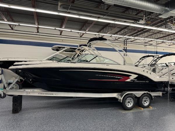 Chaparral 23 SSi 2024 Chaparral 23 SSi boat on trailer in showroom.