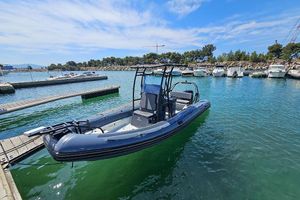 Zodiac Pro 7 2023 Zodiac Pro 7 boat docked in a marina under a clear blue sky.