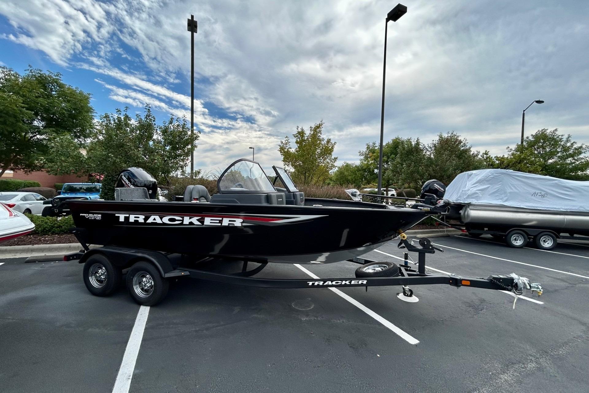 Tracker Pro Guide V-175 Combo 2026 Tracker Pro Guide V-175 Combo boat on trailer in parking lot.