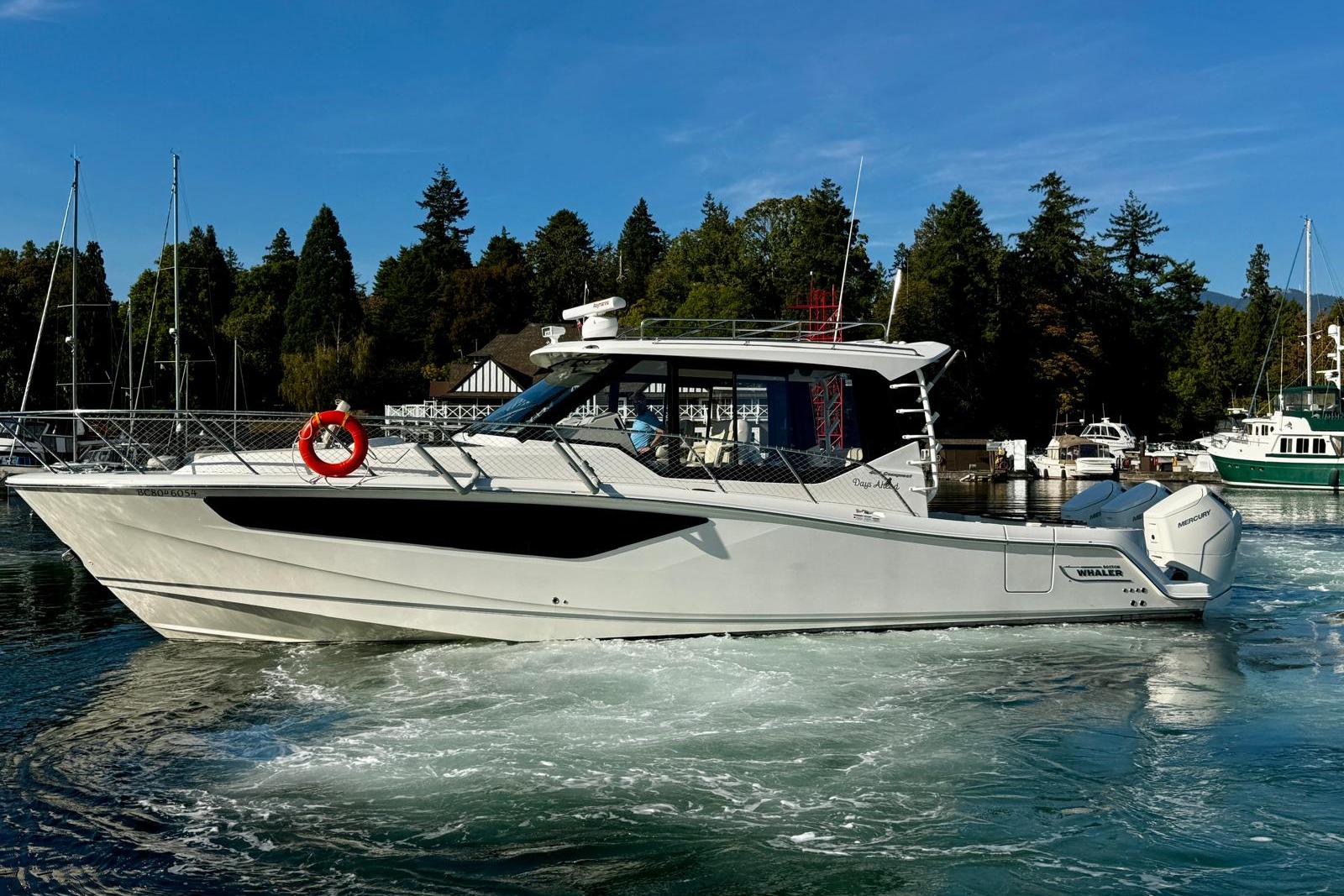 Boston Whaler 405 Conquest 2022 Boston Whaler 405 Conquest boat cruising in a scenic marina setting.
