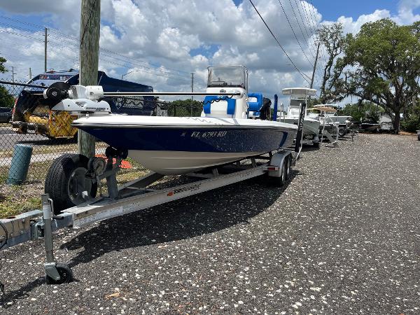 ShearWater 23LTZ 2017 ShearWater 23LTZ boat on trailer, parked outdoors under a partly cloudy sky.