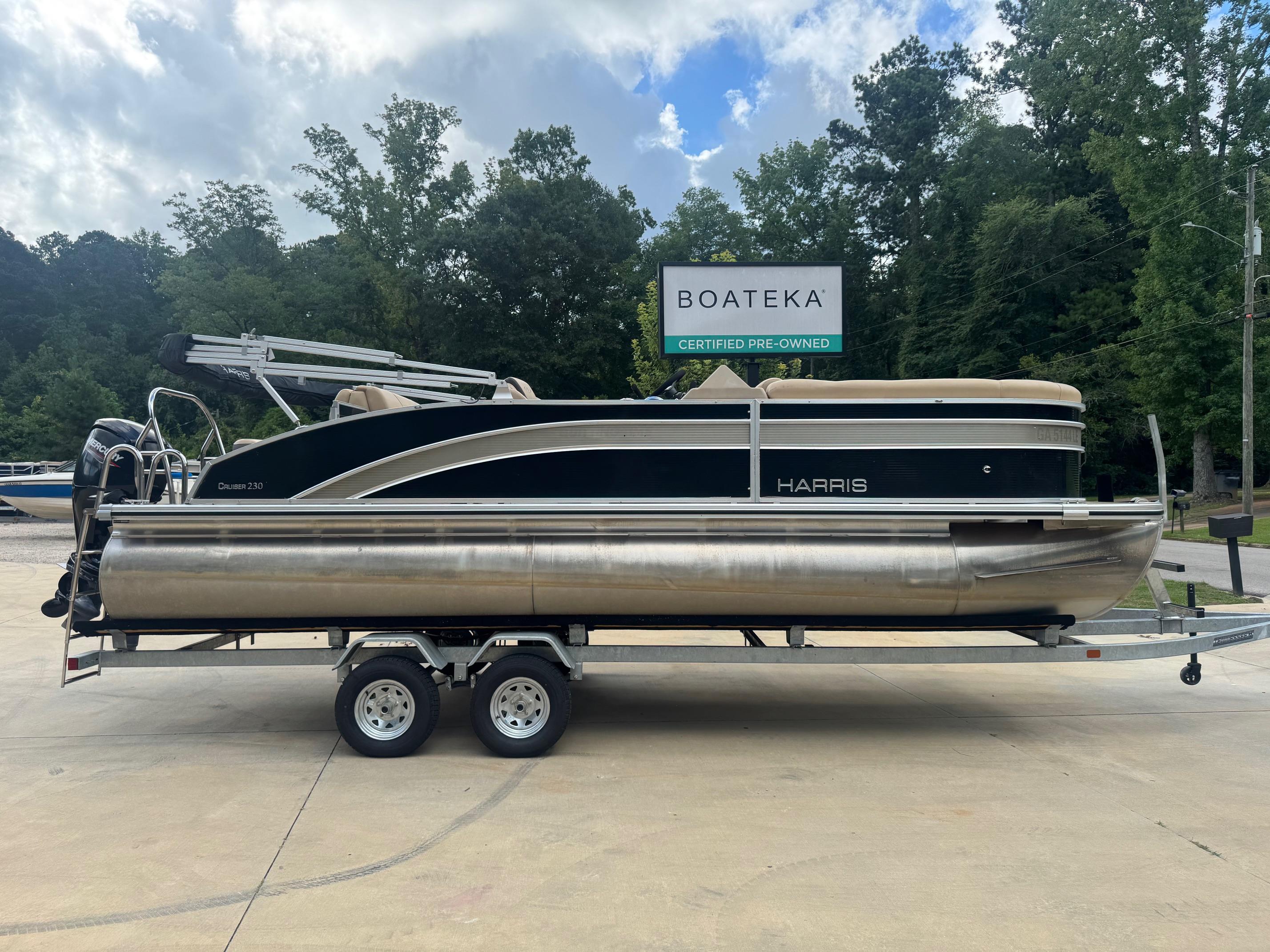 Harris Cruiser 230 2022 Harris Cruiser 230 pontoon boat on trailer, certified pre-owned, outdoor setting.
