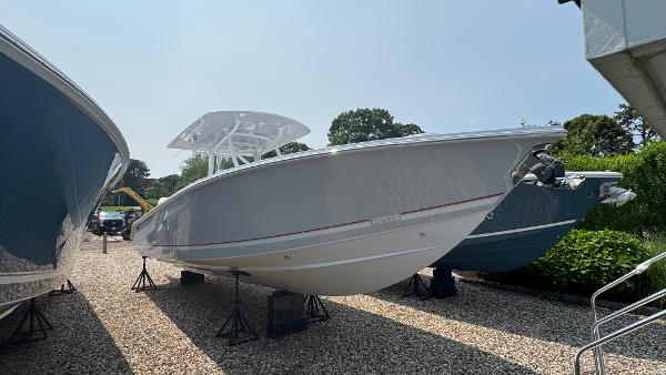 Jupiter 32 2026 Jupiter 32 boat on display, sleek design, parked on gravel lot.
