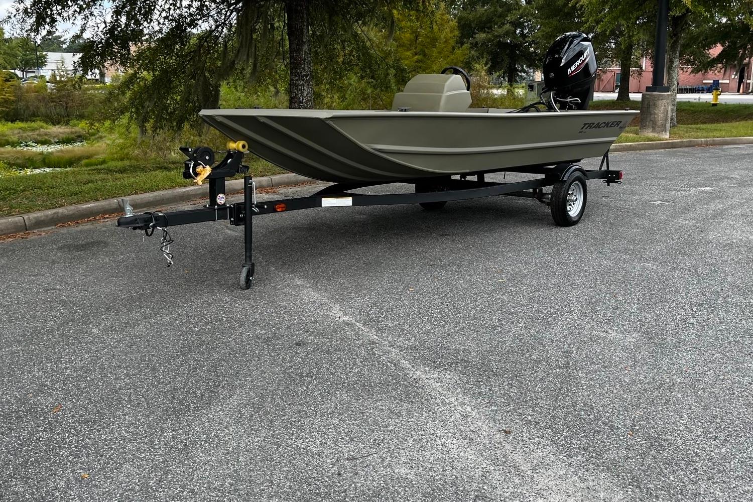 Tracker Grizzly 1648 SC 2025 Tracker Grizzly 1648 SC boat on trailer in parking lot.
