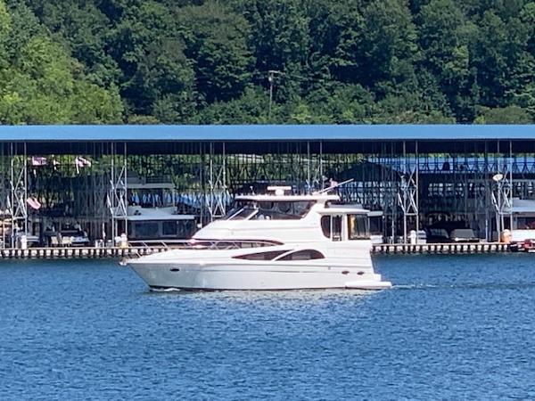 Carver 46 Motor Yacht 2005 Carver 46 Motor Yacht cruising on a lake near a marina.