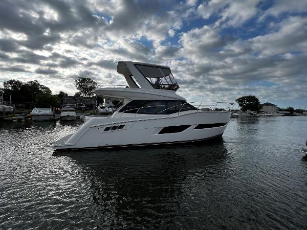 Carver C40 2020 Carver C40 yacht on a calm waterway under a partly cloudy sky.