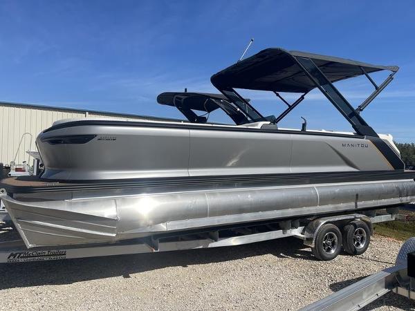 Manitou Explore 26 SHP 2024 Manitou Explore 26 SHP pontoon boat on a trailer, side view.