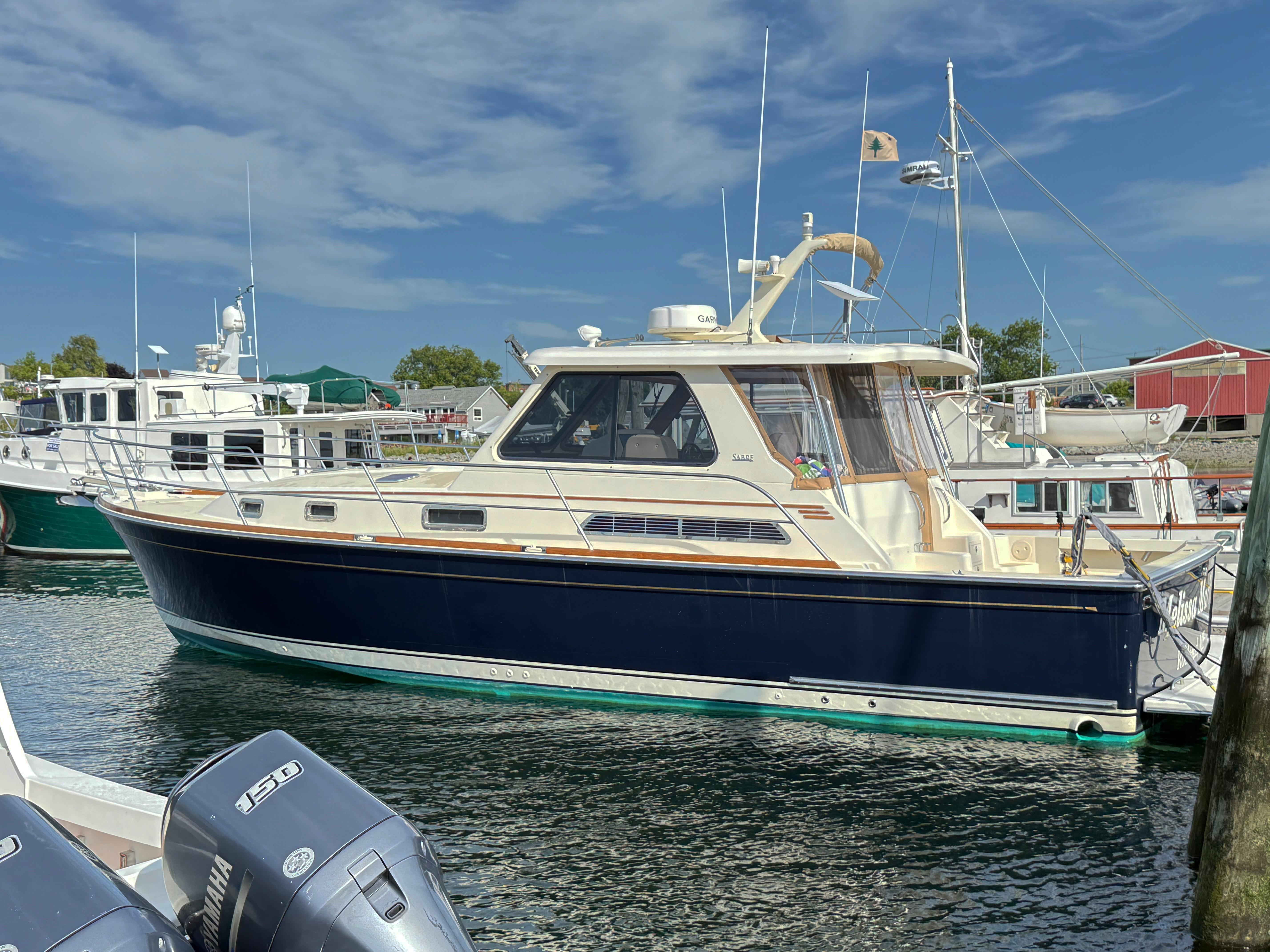 Sabre 38 Hardtop Express 2006 Sabre 38 Hardtop Express yacht docked in marina under clear blue sky.