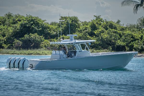 Valhalla Boatworks V-41 2023 Valhalla Boatworks V-41 cruising on blue water near lush greenery.