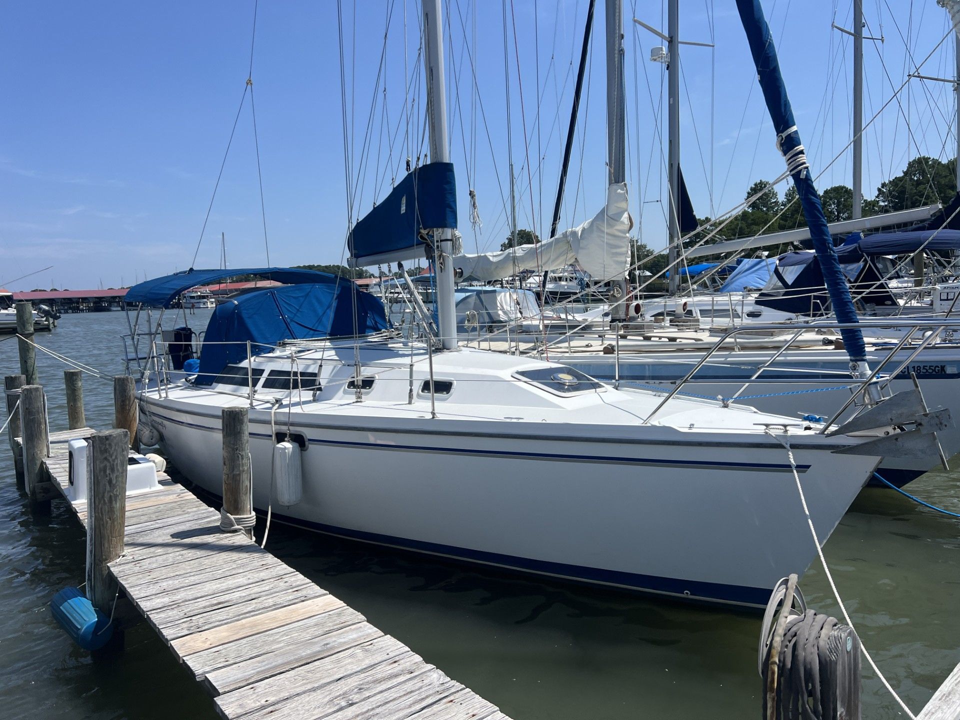 Catalina 320 1994 Catalina 320 sailboat docked at a marina on a sunny day.
