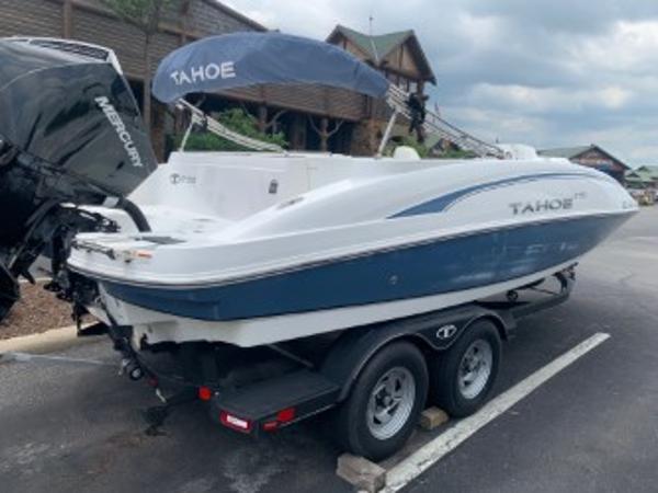 Tahoe 2150 Deck Boat 2023 Tahoe 2150 Deck Boat on trailer, parked outdoors with Mercury engine.