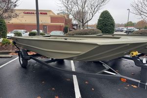Tracker Grizzly 1754 Utility 2026 Tracker Grizzly 1754 Utility boat on trailer in parking lot.