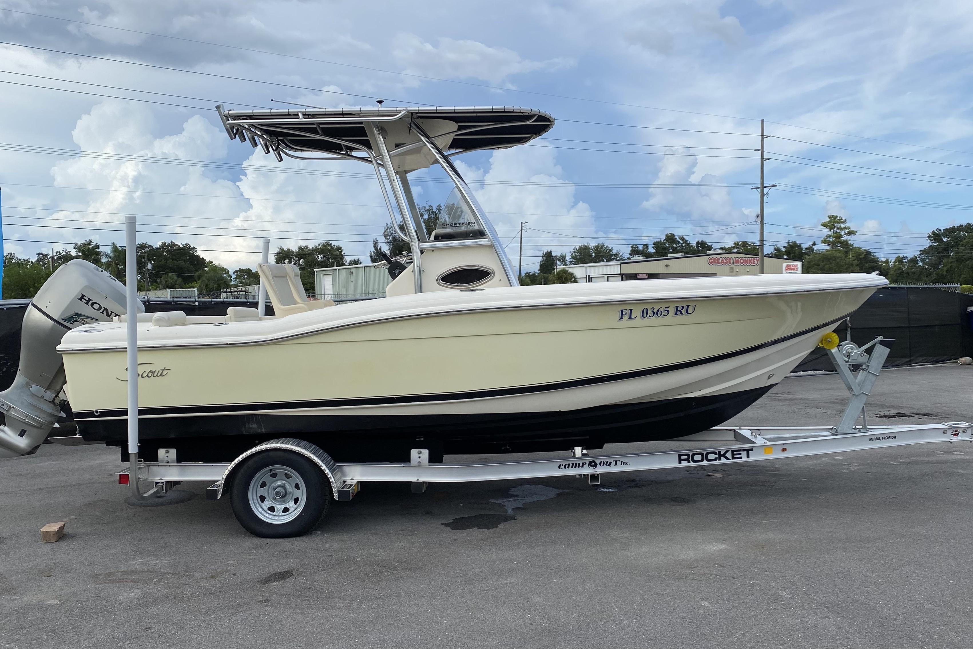 Scout 210 Sportfish 2005 Scout 210 Sportfish boat on trailer, side view, with Honda outboard motor.