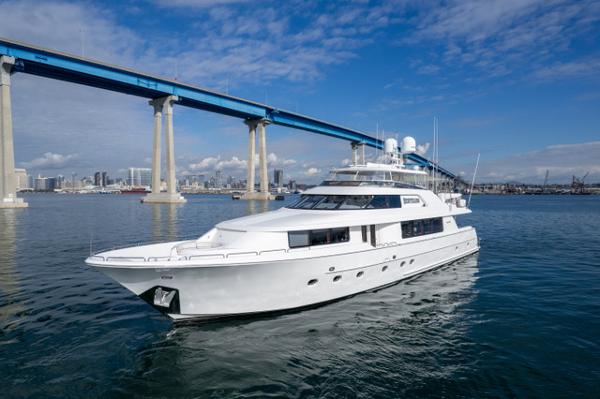 Westport Raised Pilothouse Luxury 2008 Westport Raised Pilothouse yacht cruising under a blue sky near a bridge.