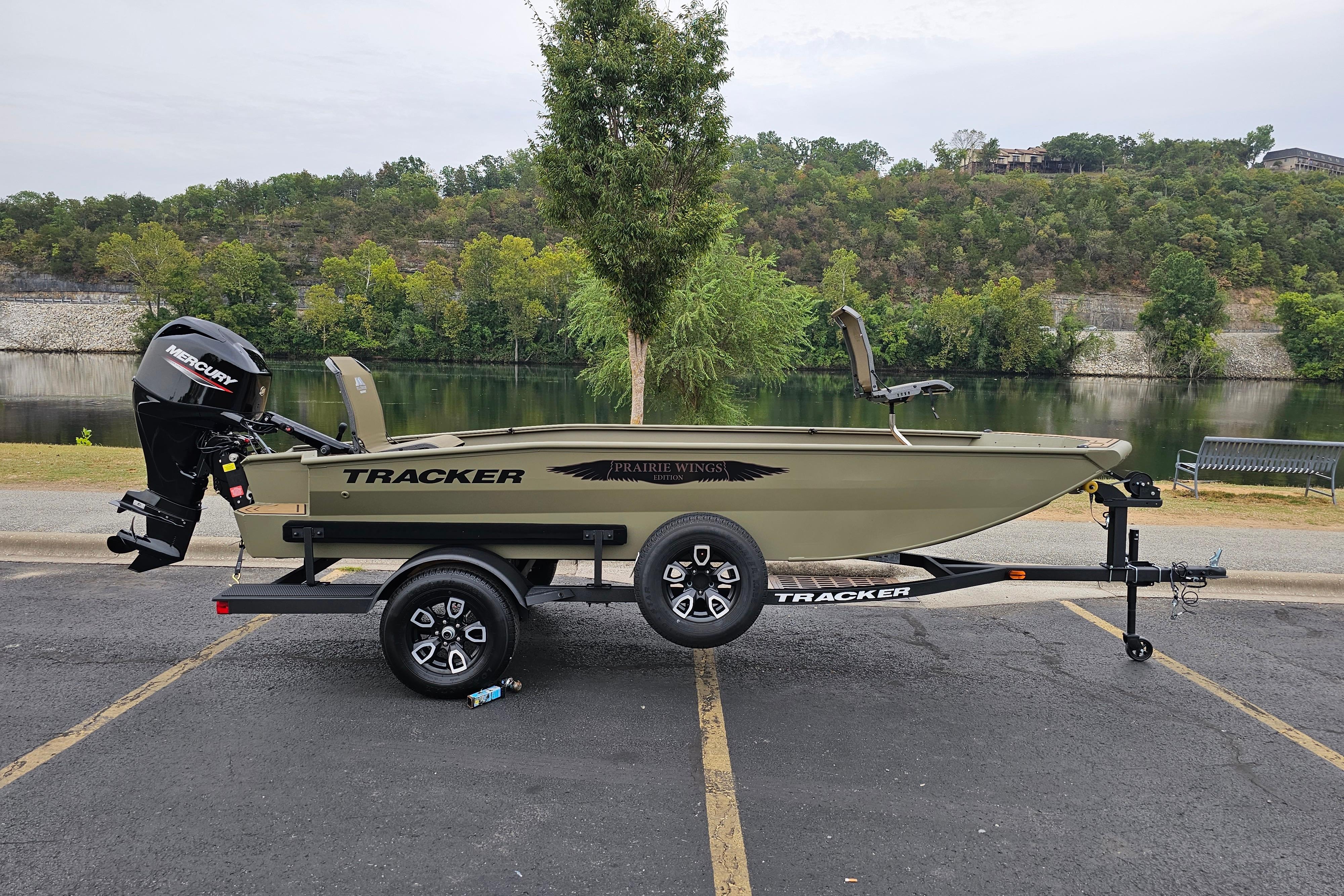 Tracker Grizzly 1650 T Prairie Wings Edition 2026 Tracker Grizzly 1650 T Prairie Wings Edition boat on trailer by a scenic lake.