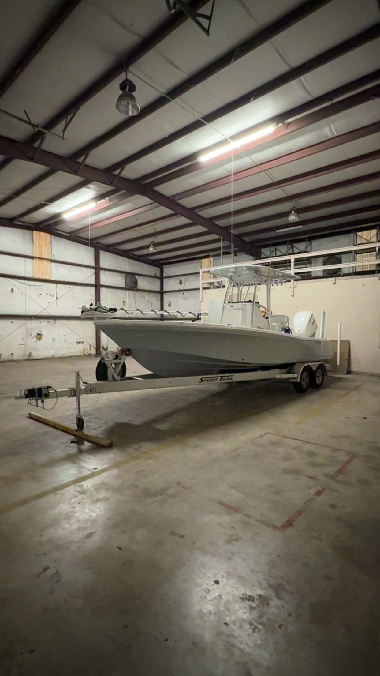 BlackJack 256 Bay 2025 BlackJack 256 Bay boat on trailer in spacious indoor storage facility.