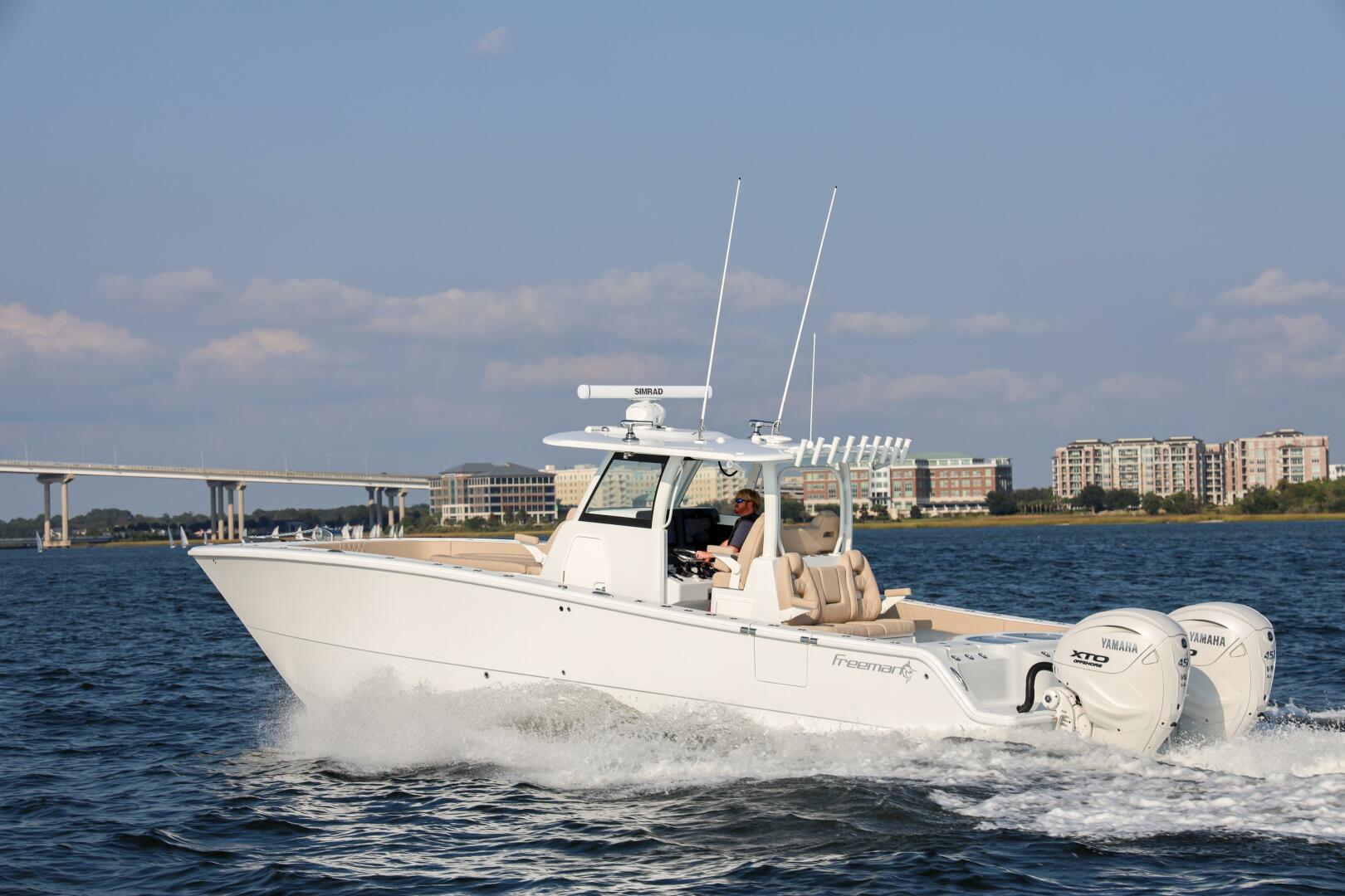 Freeman 35 2026 Freeman 35 boat cruising on water with cityscape background.