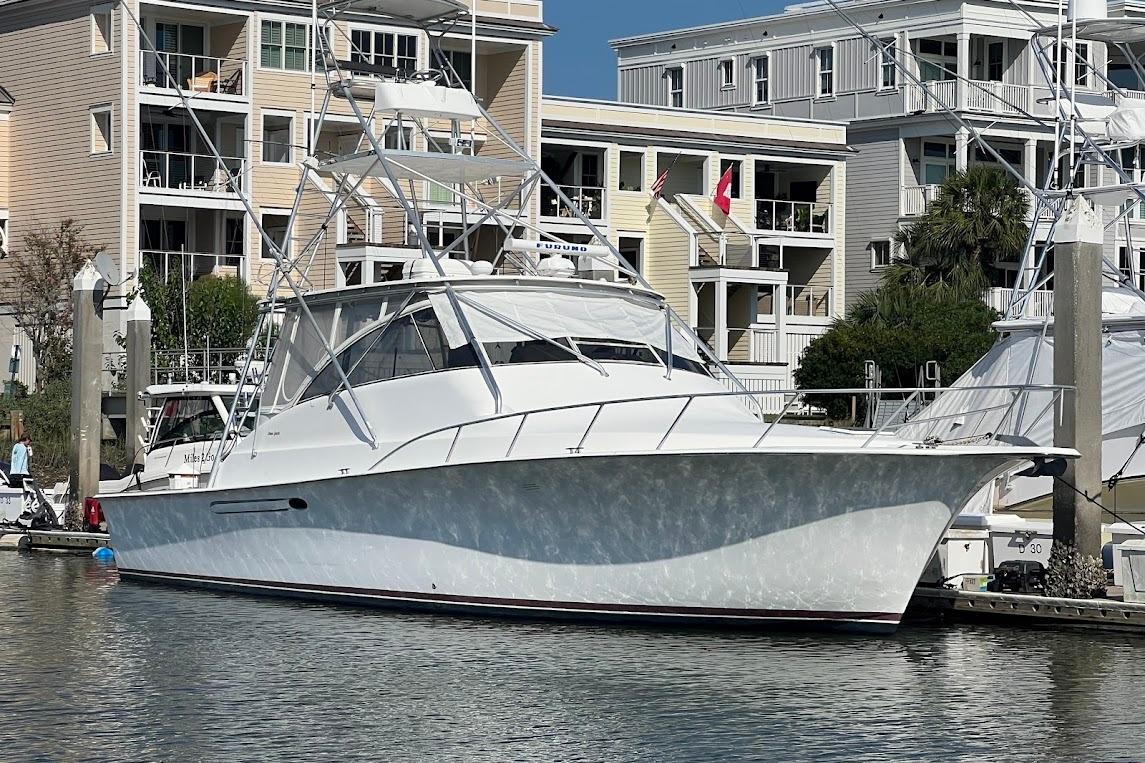 Ocean Yachts Sport Fish 1999 Ocean Yachts EXPRESS docked near waterfront buildings.
