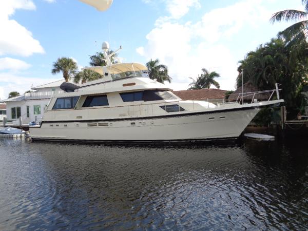 Hatteras 67 Cockpit Motor Yacht 1989 Hatteras 67 Cockpit Motor Yacht docked by palm trees.
