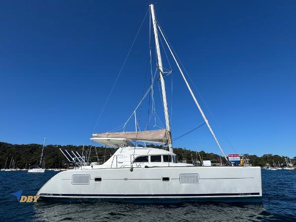 Lagoon 380 2010 Lagoon 380 catamaran sailing on calm waters under clear blue sky.