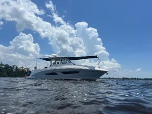 Regal 33 SAV 2019 Regal 33 SAV boat on water under blue sky with clouds.