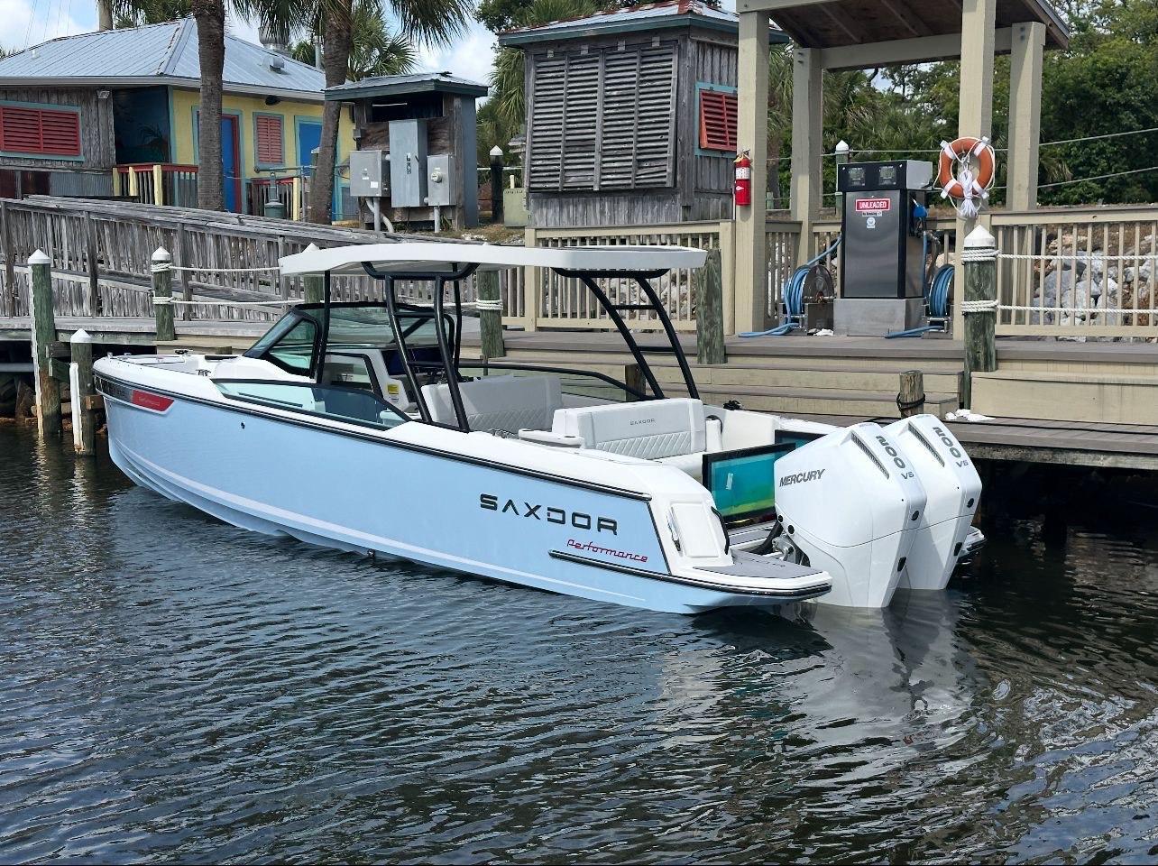 Saxdor 270gto 2025 Saxdor 270gto boat docked with twin Mercury engines, near a wooden pier.