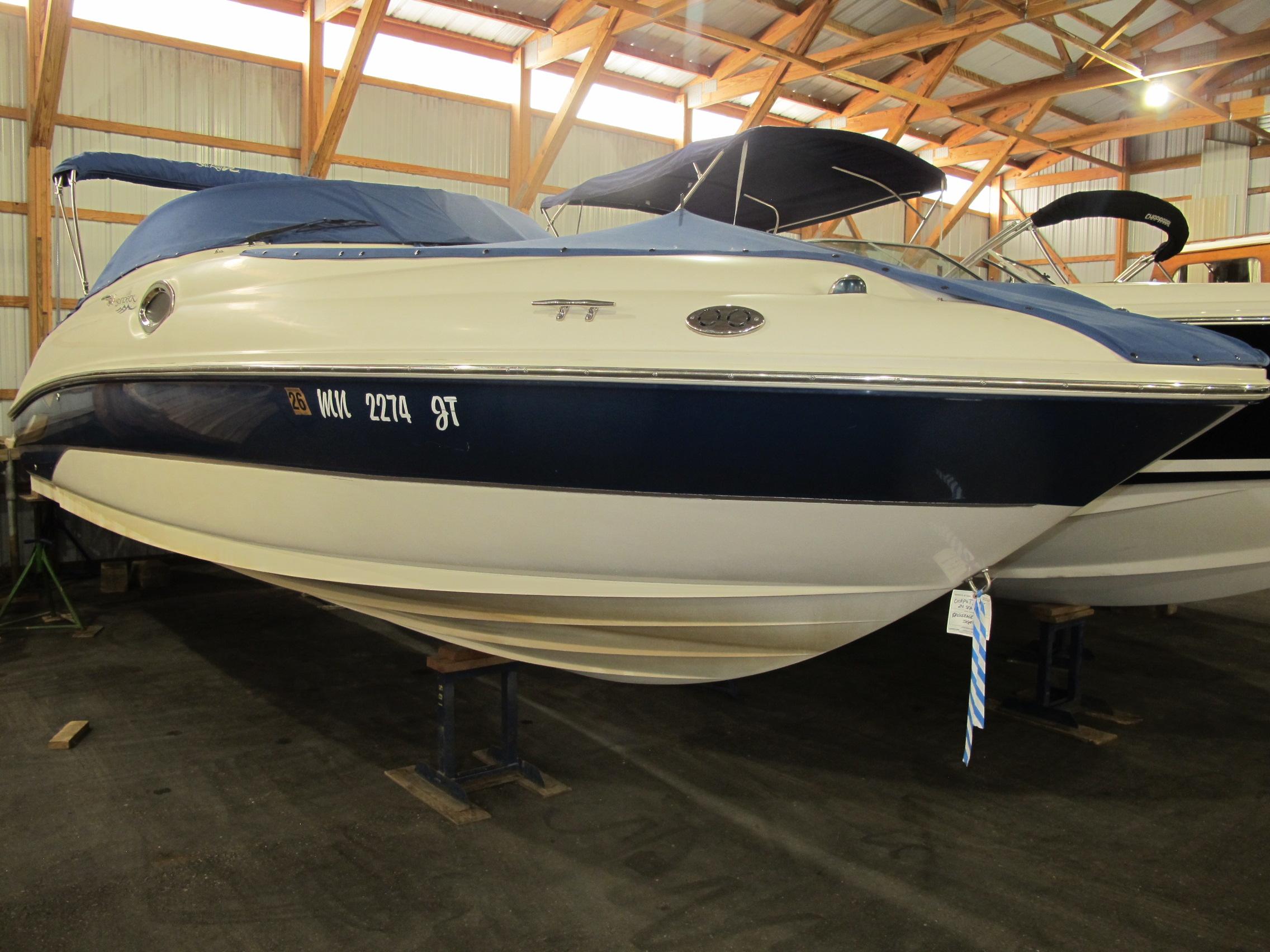 Sea Ray 240 Sundeck 2004 Sea Ray 240 Sundeck boat in indoor storage, blue and white exterior.