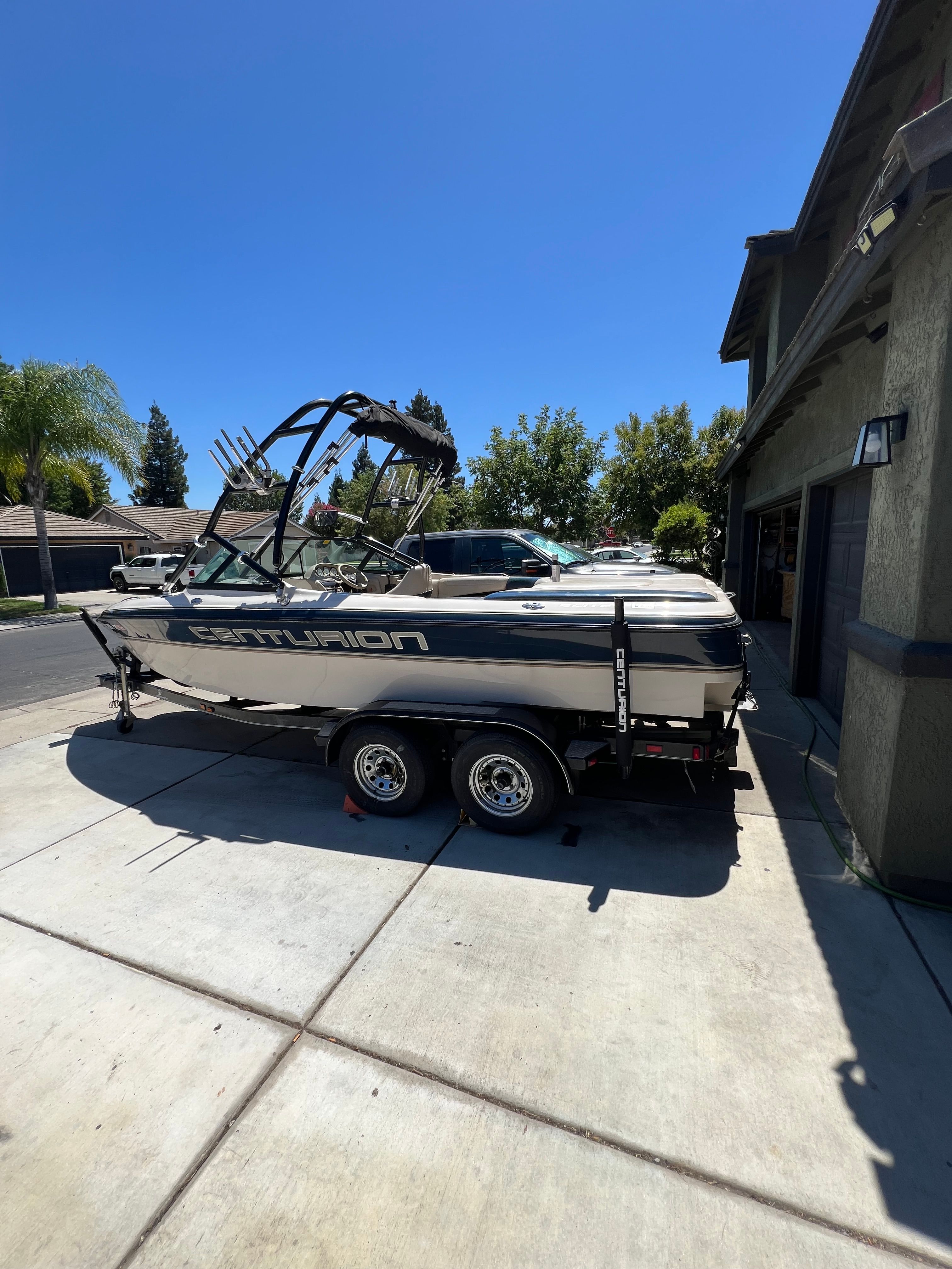 Ski Centurion Air warrior Elite V 2000 Ski Centurion Air Warrior Elite V boat on trailer in driveway.