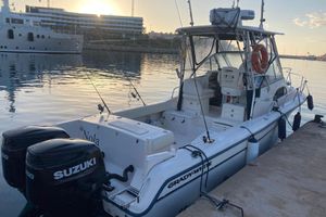 Grady-White Sailfish 282 2009 Grady-White Sailfish 282 boat docked with dual Suzuki engines at sunset.