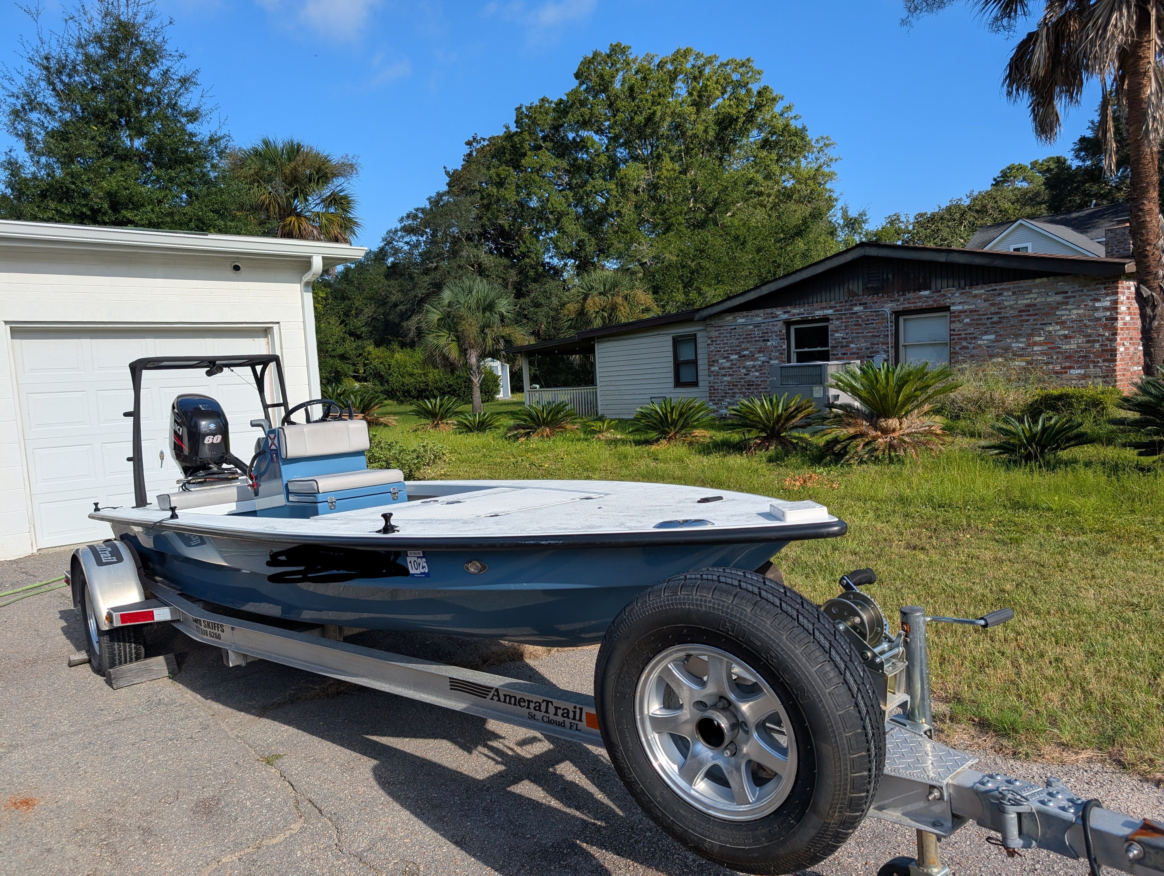 Cayo Boatworks 173 2016 Cayo Boatworks 173 on trailer, parked in driveway near house and greenery.