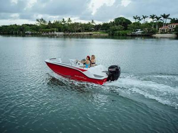 Bayliner M15 2025 Bayliner M15 boat cruising on a serene lake with lush greenery.