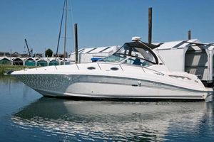 Sea Ray 340 Sundancer 2004 Sea Ray 340 Sundancer yacht docked in a marina under clear blue skies.