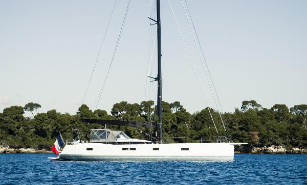 CNB 66 Sleek 2021 CNB 66 yacht sailing near a forested coastline.
