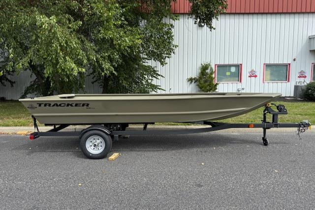 Tracker Grizzly 1648 Utility 2026 Tracker Grizzly 1648 Utility boat on trailer, parked outdoors near a building.