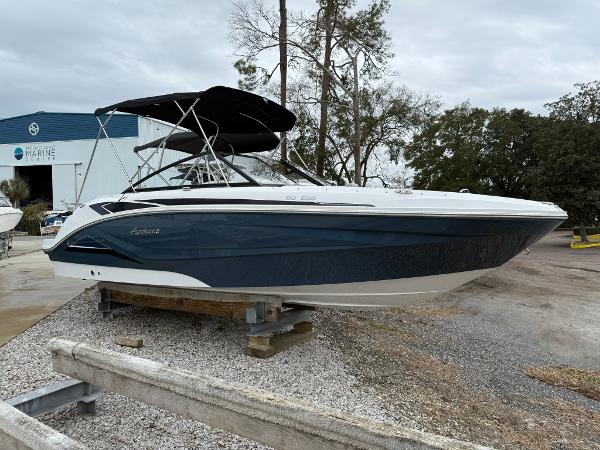 Hurricane SunDeck 235 OB 2025 Hurricane SunDeck 235 OB boat on display at a marina.