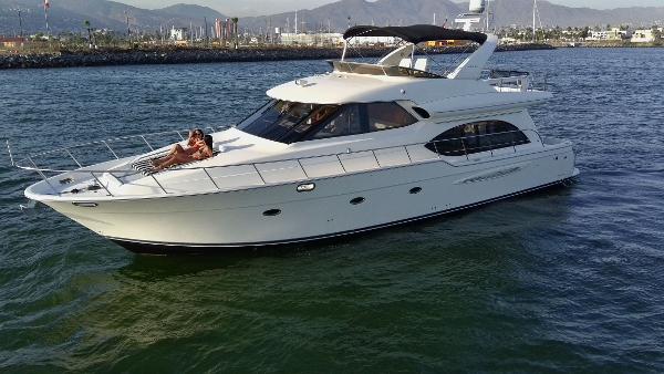 Meridian 580 Pilothouse 2004 Meridian 580 Pilothouse yacht cruising on calm waters with scenic background.