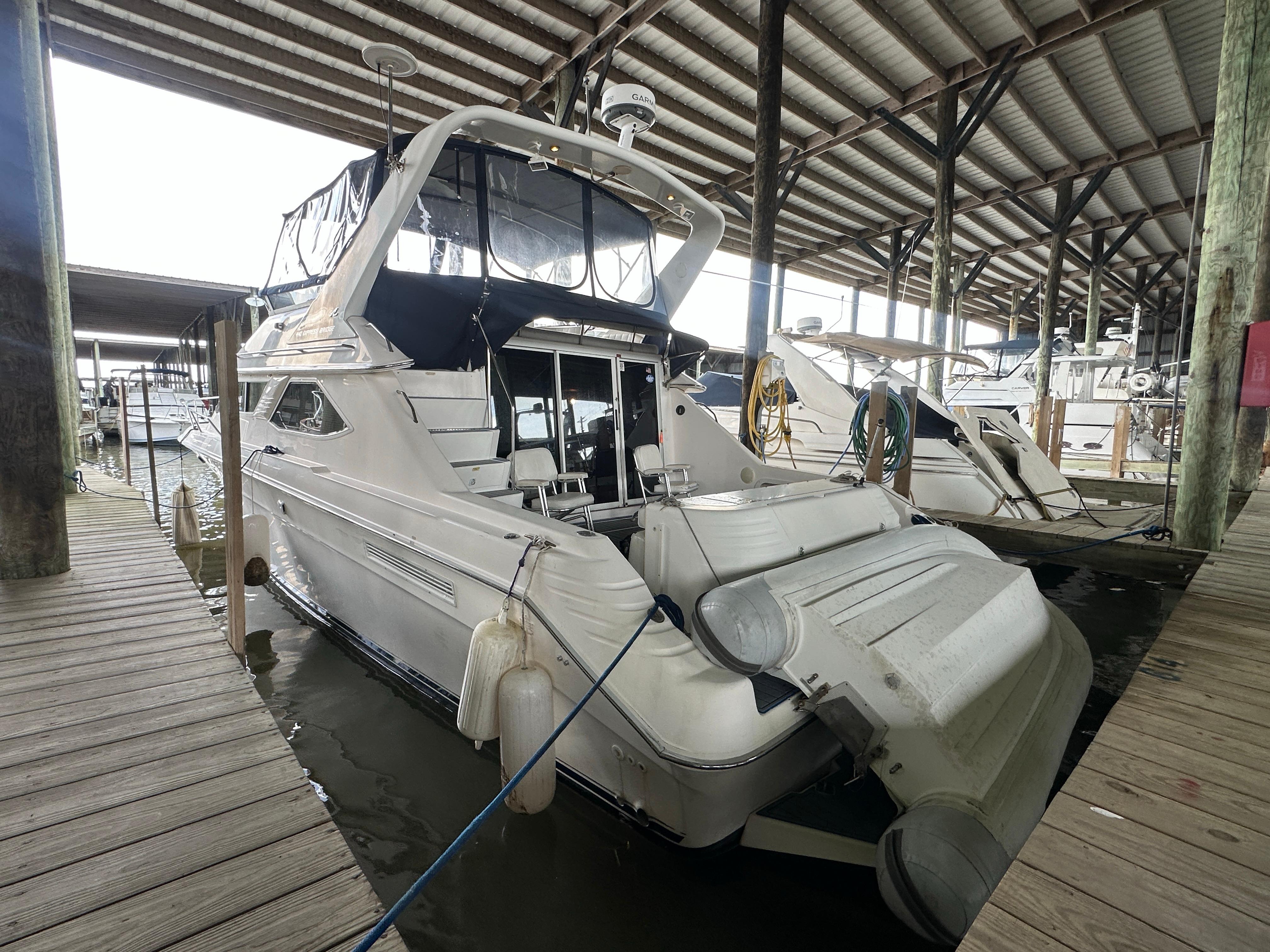 Sea Ray 440 Express Bridge 1996 Sea Ray 440 Express Bridge docked in a covered marina.