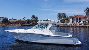 Tiara Yachts 3200 Open 2006 Tiara Yachts 3200 Open cruising on a sunny day near waterfront homes.