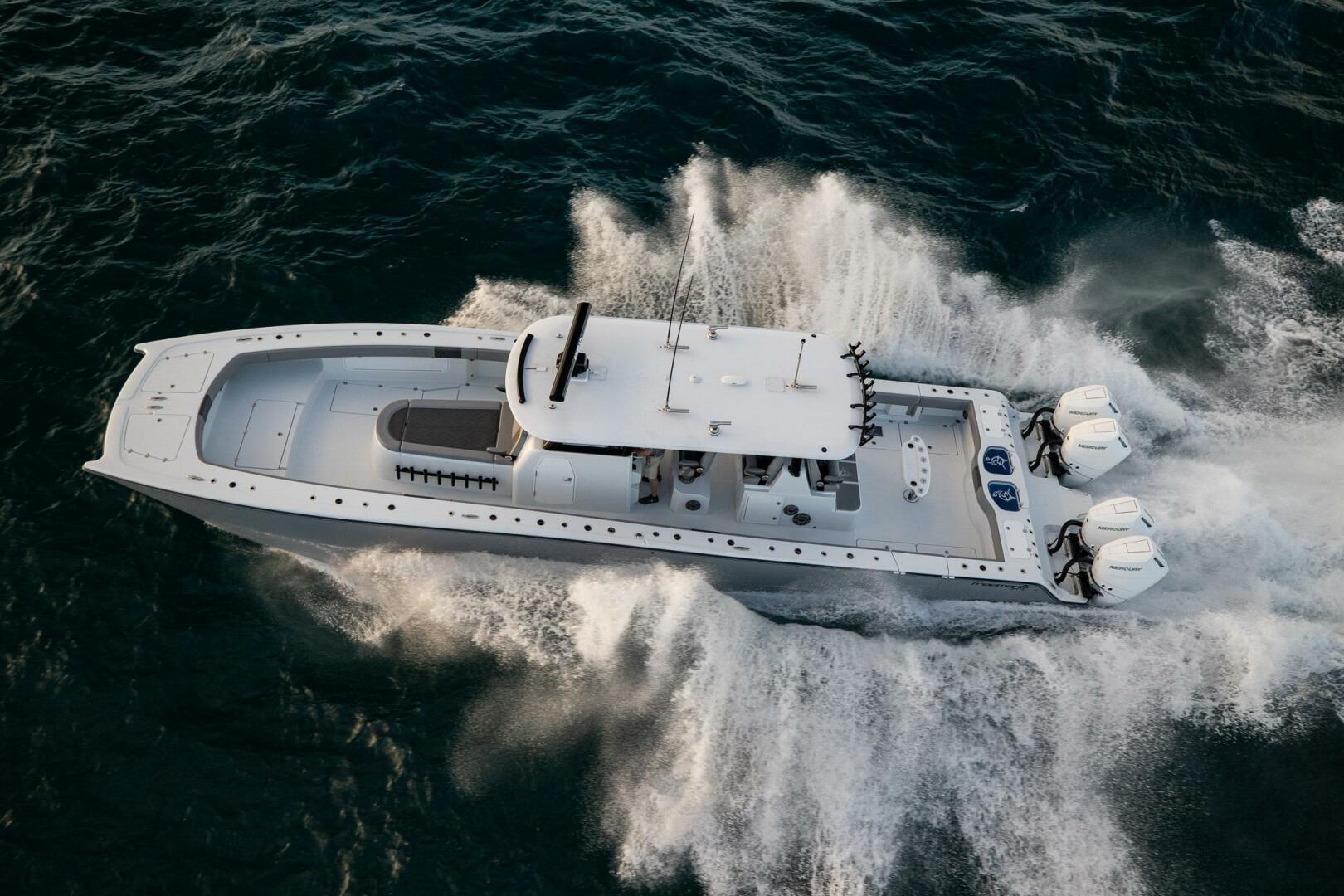 Freeman 47LX Aerial view of 2026 Freeman 47LX boat speeding on the ocean.