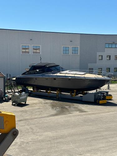 Baia FLASH 48 Baia FLASH 48 yacht, 2001 model, on dry dock near industrial building.