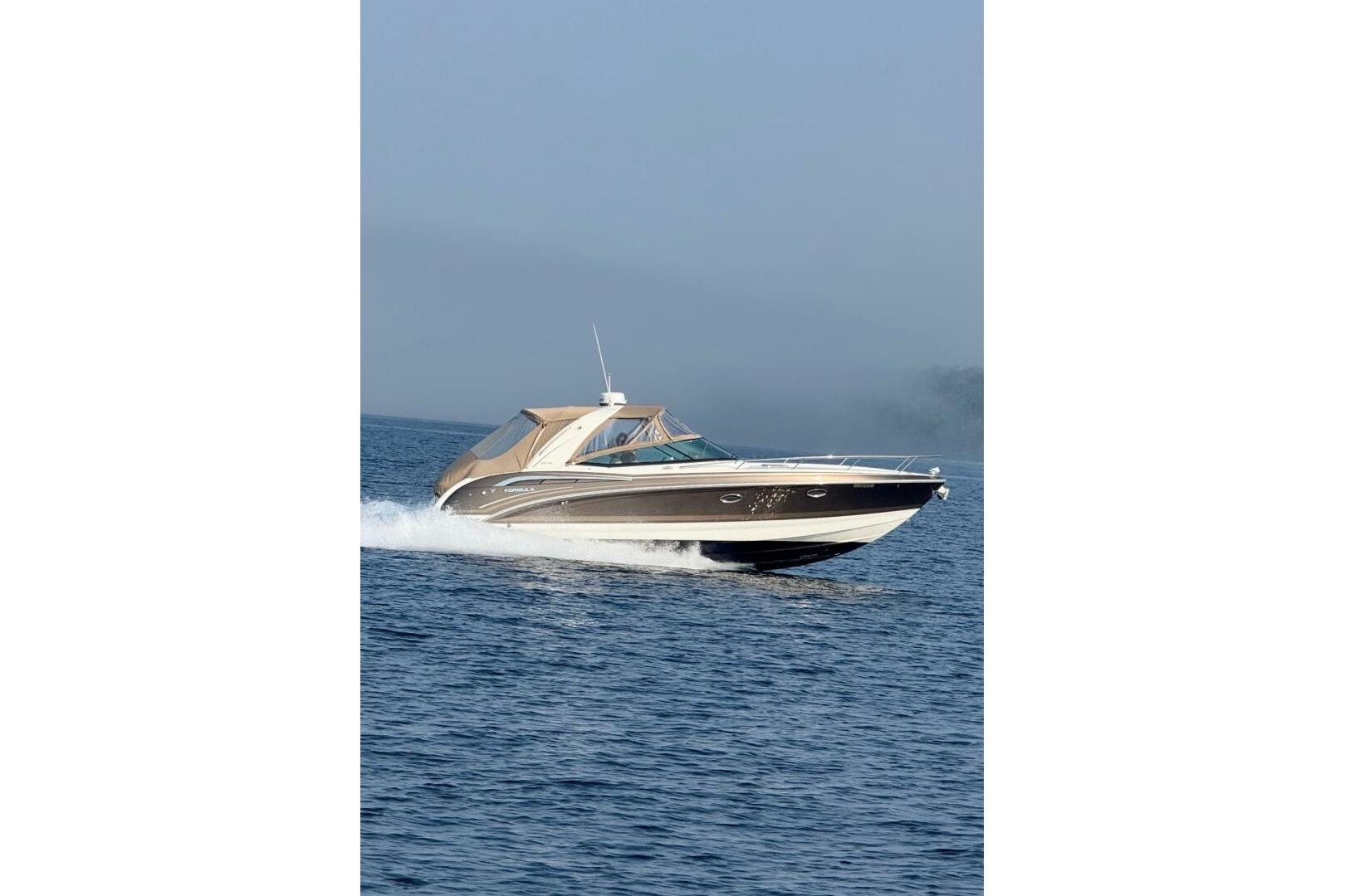 Formula 350 Ss 2016 Formula 350 Sunsport cruising on open water, showcasing sleek design and performance.