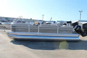 Sun Tracker Party Barge 22 RF DLX 2025 Sun Tracker Party Barge 22 RF DLX pontoon boat in a marina setting.