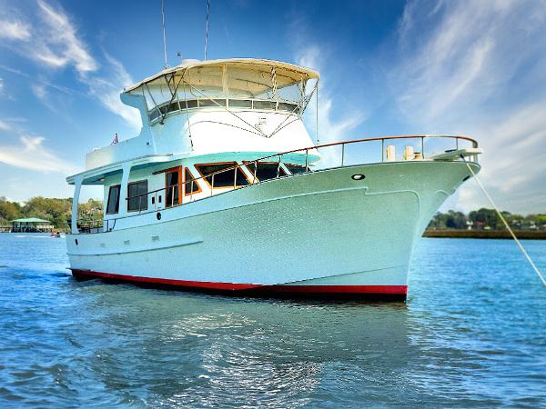 Albin Extended Flybridge trawler 1979 Albin Extended Flybridge trawler on calm water under a clear blue sky.