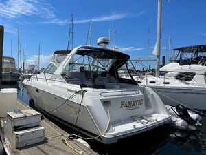 Formula 34 Performance Cruiser 2000 Formula 34 Performance Cruiser docked at marina under clear blue sky.