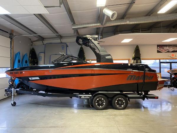 Malibu M235 2018 Malibu M235 boat in a garage, orange and black color scheme.