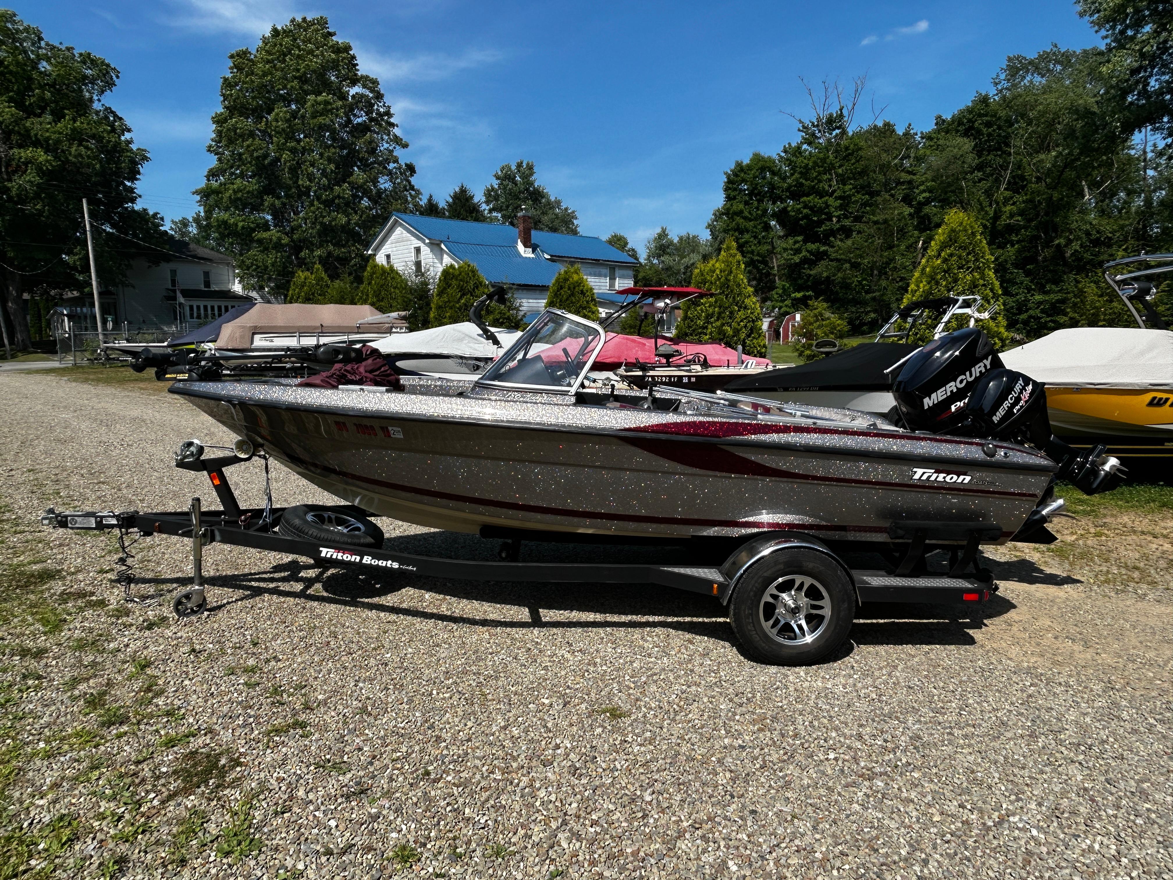 Triton 186 Fishunter 2013 Triton 186 Fishunter boat on trailer, parked outdoors on gravel.