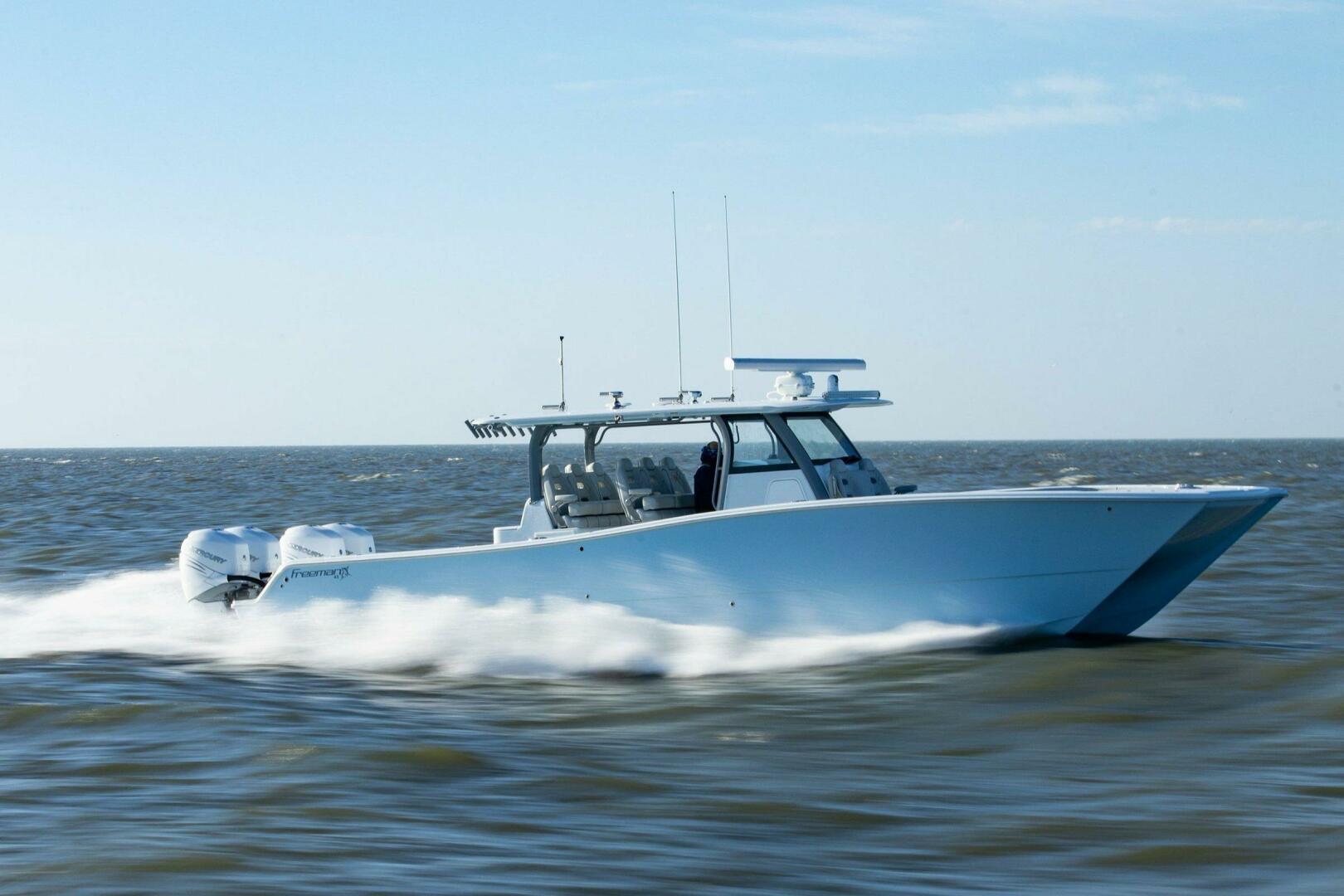Freeman 43 2026 Freeman 43 boat speeding on open water under clear skies.