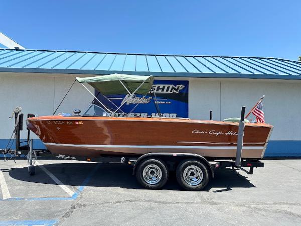 Chris-Craft Holiday 20' 1956 Chris-Craft Holiday 20' boat on trailer, wooden finish, parked outdoors.