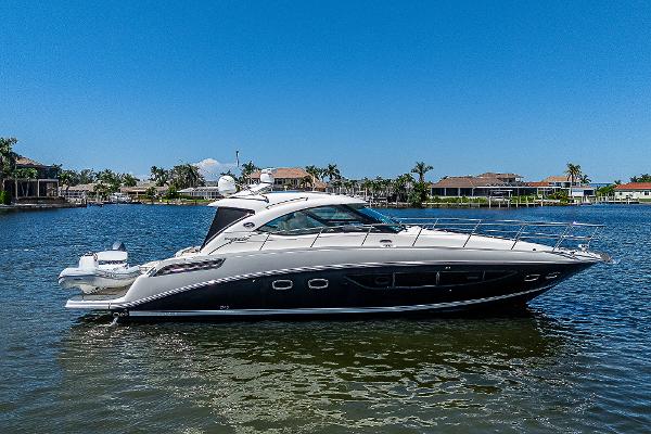 Sea Ray 470 Sundancer 2014 Sea Ray 470 Sundancer yacht on calm water, clear blue sky background.